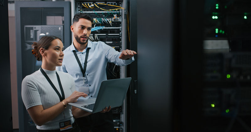 Shot of two colleagues working together in a server room